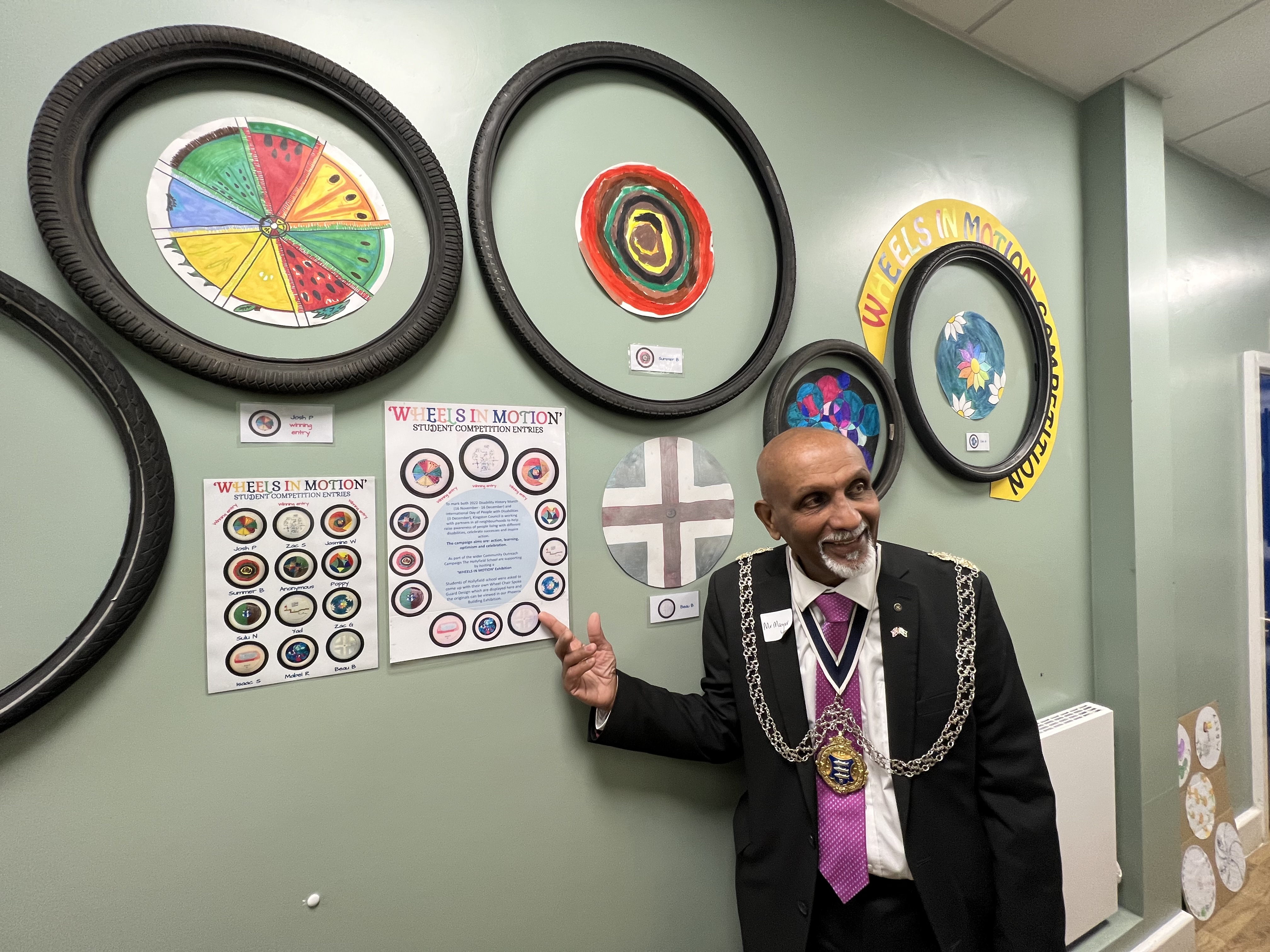 The Mayor of Kingston pointing at artwork on display at a local primary school for UK Disability History Month