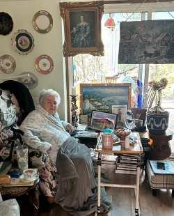 Photo of Rosa sitting in her armchair at home