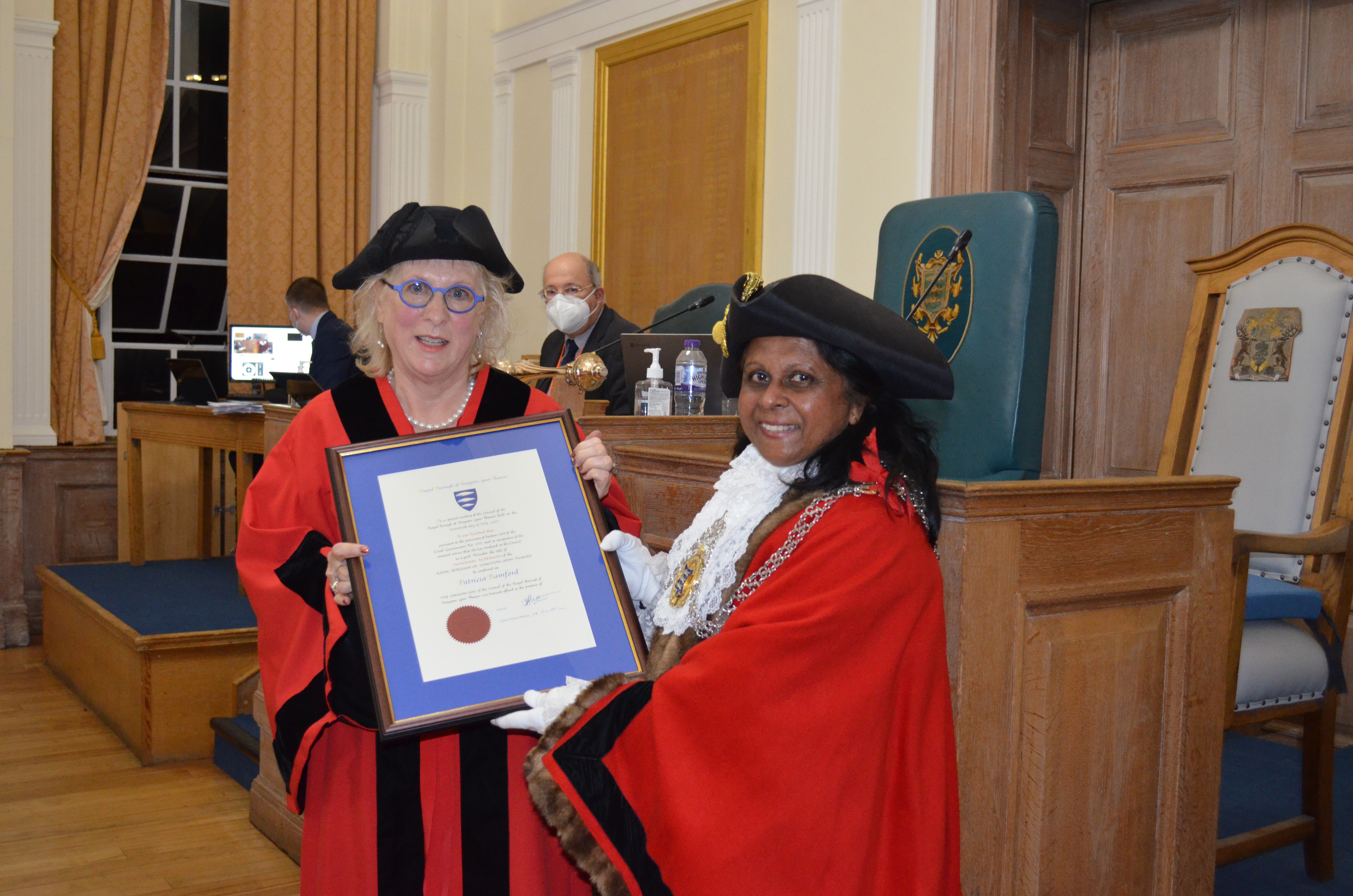 Patricia Bamford is awarded a certificate by Mayor of Kingston Cllr Sushila Abraham at the ceremony to make her an Honorary Alderman.