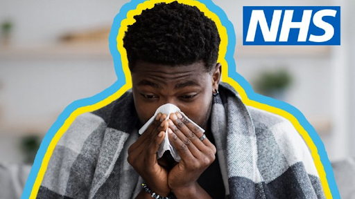 NHS image of a man wrapped in a blanket blowing his nose