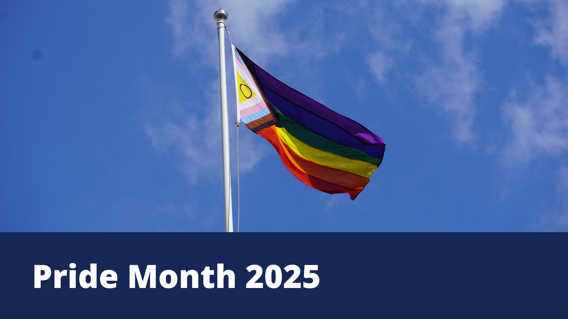 Photo of the LGBTQIA+ flag flying above the Guildhall and the words Pride Month 2025