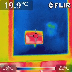 A thermal image of a window with a patch of low emissivity film reflecting heat back into the room.