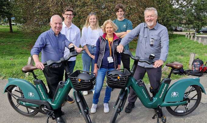 Residents standing next to first Human Forest e-bikes