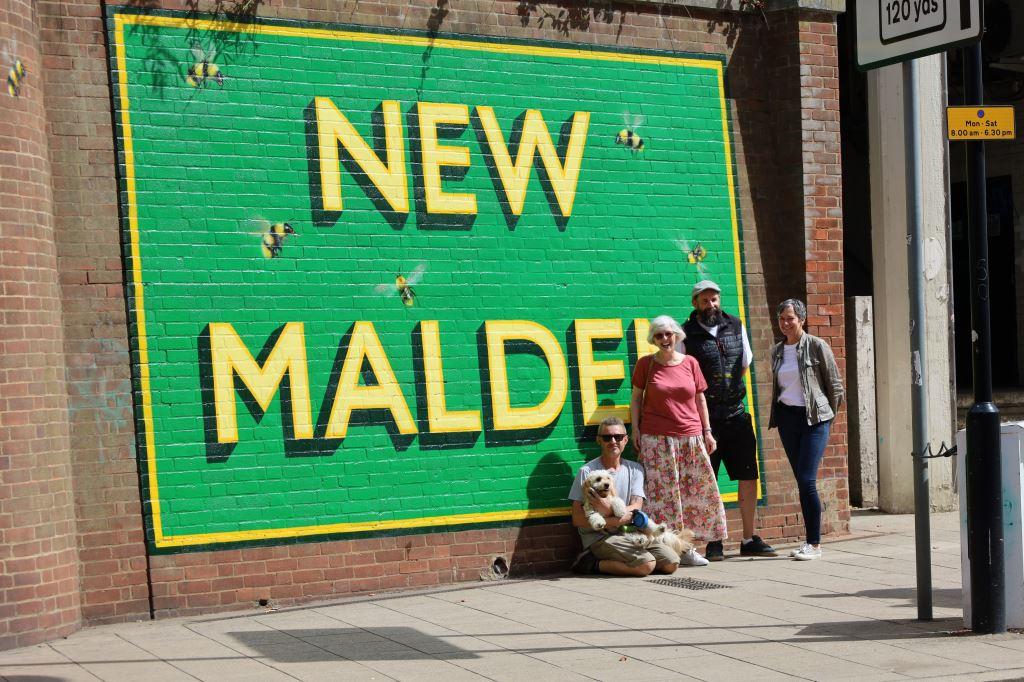Natalie Walton and friends standing outside New Malden's new station mural