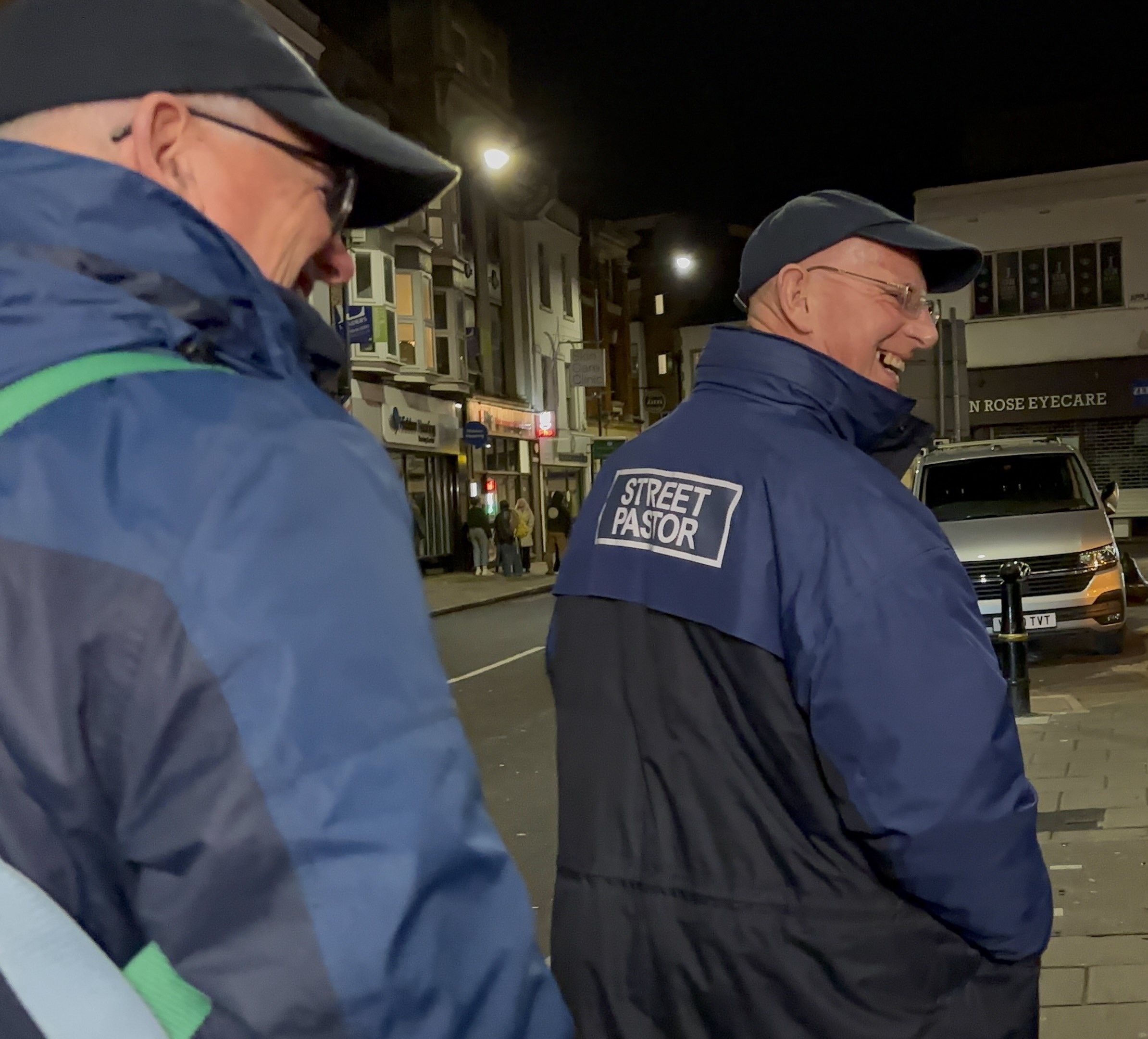 Photo of two Kingston Street Pastors, smiling at nighttime