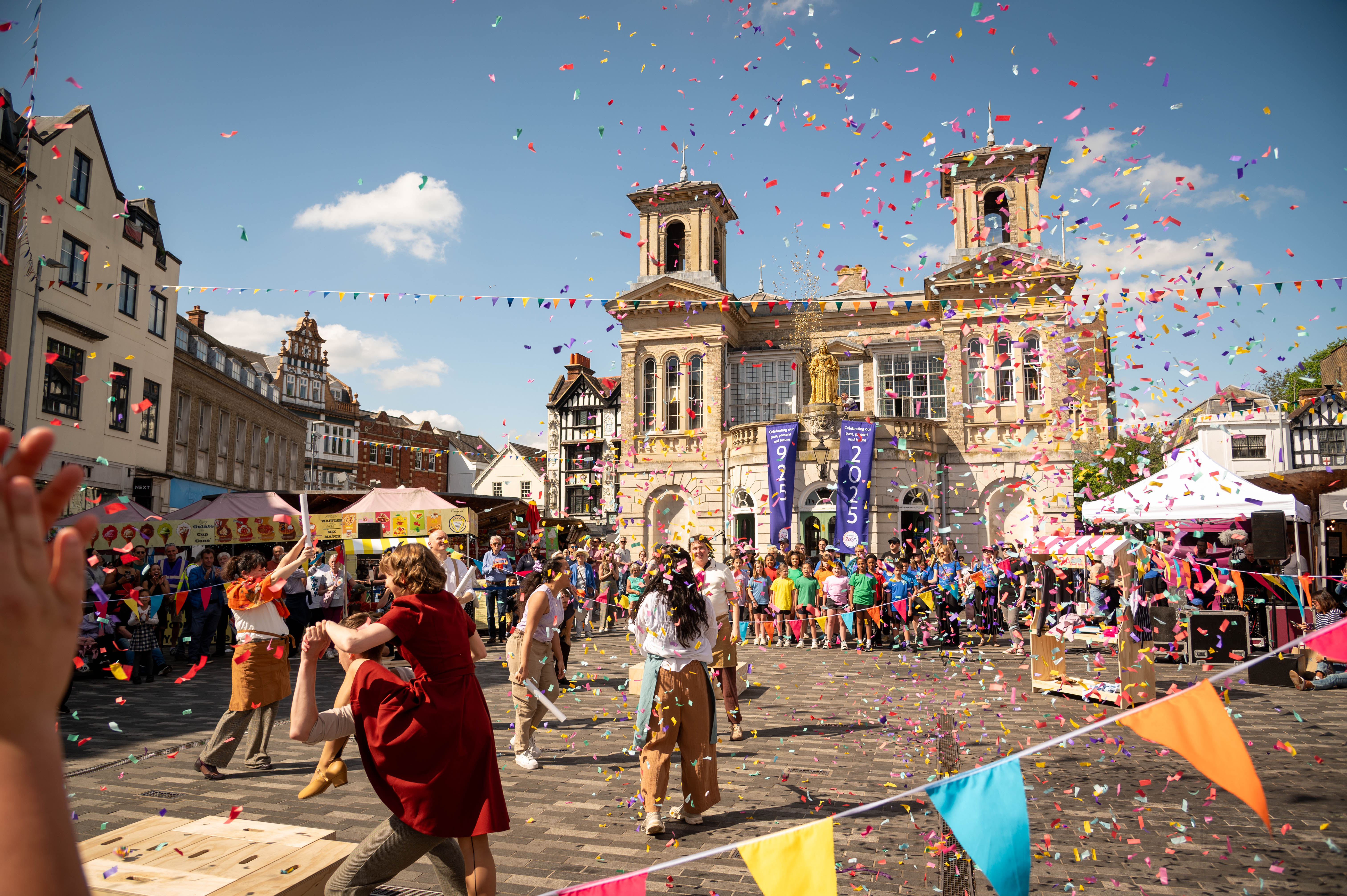 A confetti cannon showers Kingston&#039;s Ancient Market Place in coulourful tickertape as performers delight crowds at the launch of Kingston 2025.