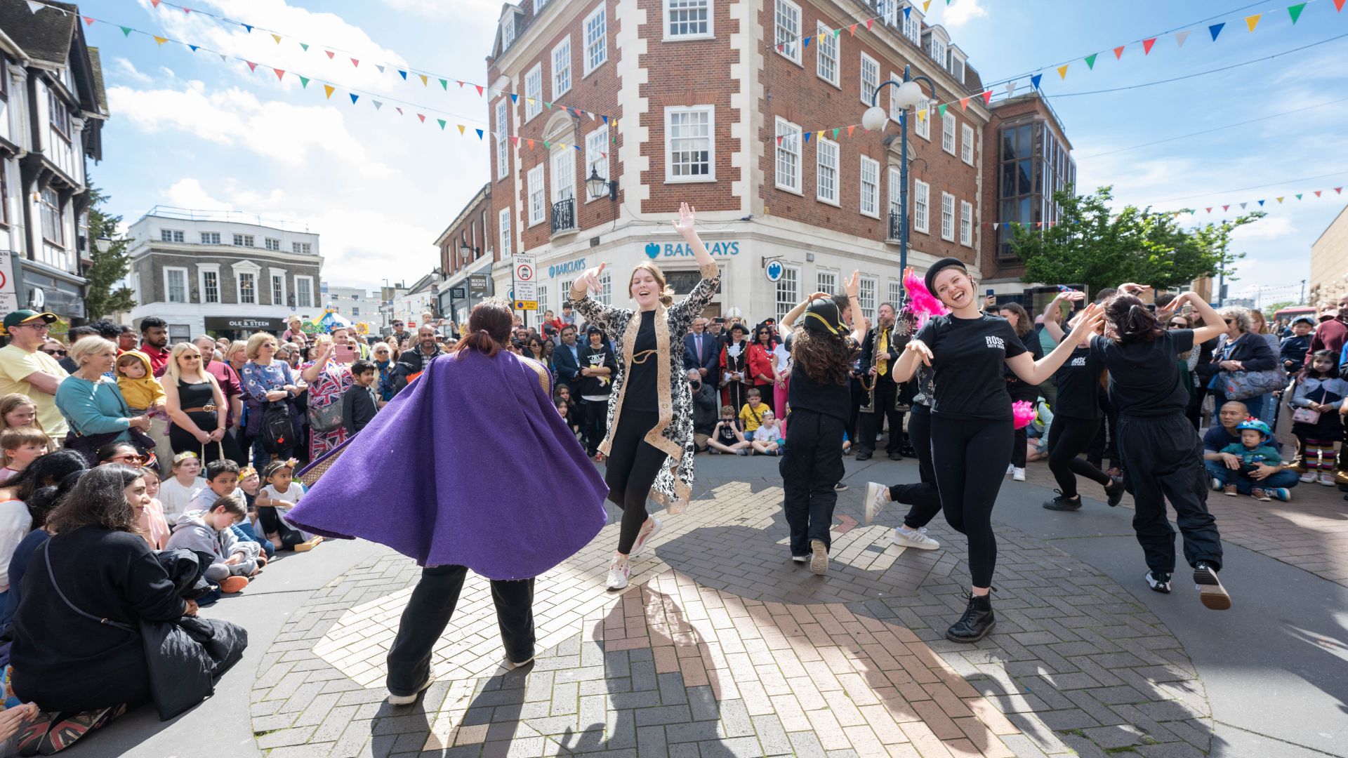 A group of people celebrating the King's coronation in Kingston town centre