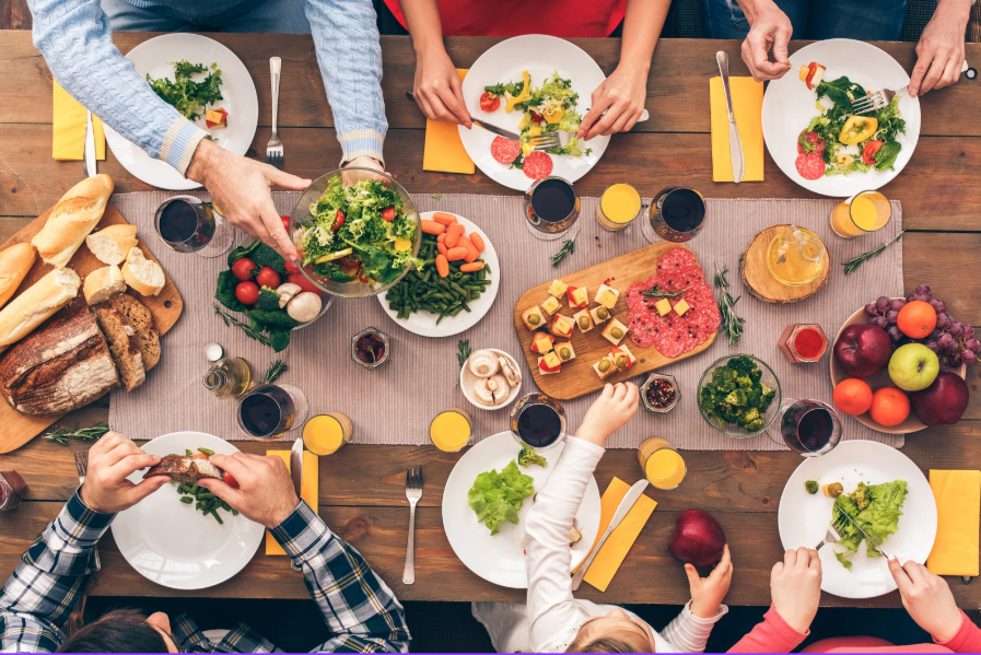 Photo of 6 places at a table set out with healthy food being served