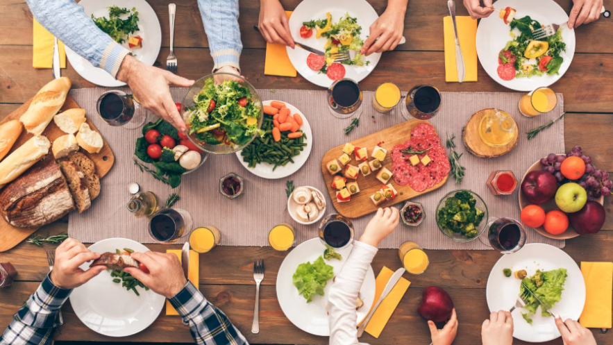 Photo of 6 places at a table set out with healthy food being served